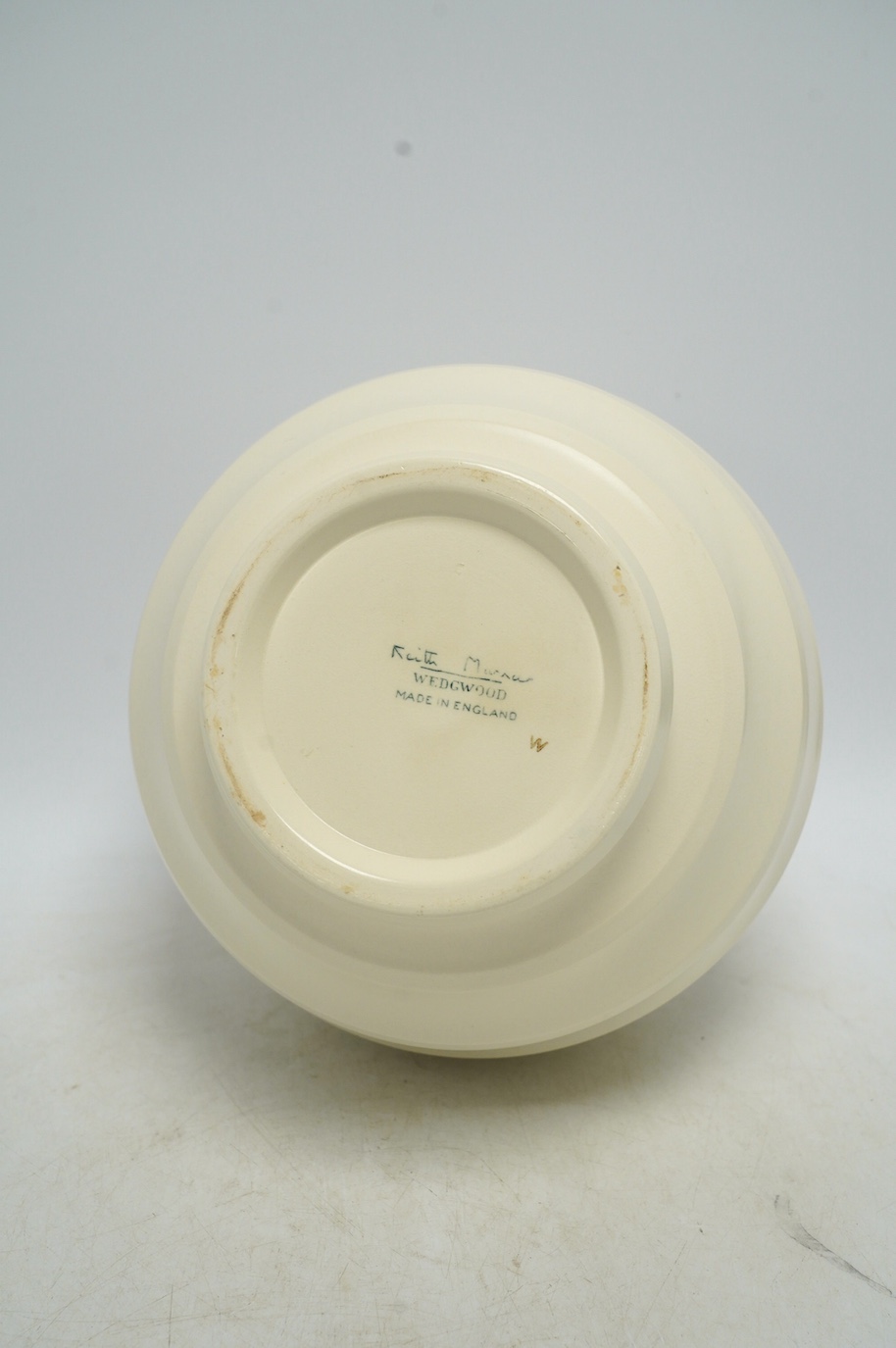 Keith Murray for Wedgwood, a cream glazed ribbed globular vase, 23cm. Condition - fair, star crack visible to base from interior